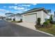 Detached garage with a concrete driveway in front of the house with manicured landscaping at 896 Tilden Oaks Trl, Winter Garden, FL 34787