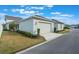 View of the detached garage of the home with a concrete driveway and manicured shrubbery at 896 Tilden Oaks Trl, Winter Garden, FL 34787