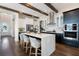 Modern kitchen with a large island, stainless steel appliances, and stylish wooden beam ceiling at 896 Tilden Oaks Trl, Winter Garden, FL 34787