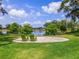 Scenic lake view with green chairs overlooking the water at 896 Tilden Oaks Trl, Winter Garden, FL 34787