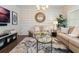Bright living room featuring elegant furniture, an accent wall, and a glass-top coffee table at 896 Tilden Oaks Trl, Winter Garden, FL 34787