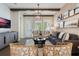 Open-concept living room with hardwood floors, stylish furniture, and natural light at 896 Tilden Oaks Trl, Winter Garden, FL 34787