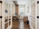Inviting home office with hardwood floors, a modern desk, and stylish decor at 896 Tilden Oaks Trl, Winter Garden, FL 34787