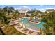 Stunning community pool with palm trees, lounge chairs and umbrellas creating a resort style ambiance at 896 Tilden Oaks Trl, Winter Garden, FL 34787