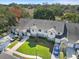 Aerial view of townhomes showcasing landscaped lawns, attached garages, and community setting at 923 Lexington Pkwy # 14, Apopka, FL 32712