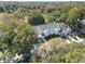 Aerial view of townhomes surrounded by mature trees, manicured lawns, and ample parking, providing a serene and inviting atmosphere at 923 Lexington Pkwy # 14, Apopka, FL 32712