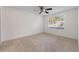 Bright carpeted bedroom featuring a ceiling fan and large window at 923 Lexington Pkwy # 14, Apopka, FL 32712