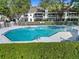 Exterior view of the community pool with lush perimeter foliage at 923 Lexington Pkwy # 14, Apopka, FL 32712