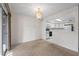 Image of dining area featuring carpet, white walls, chandelier, and open to the kitchen at 923 Lexington Pkwy # 14, Apopka, FL 32712