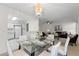 Open dining space with a glass-top table, seamlessly connecting to the living room area at 923 Lexington Pkwy # 14, Apopka, FL 32712