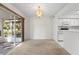 Well-lit dining area with a glass slider, an elegant chandelier, and easy access to the kitchen at 923 Lexington Pkwy # 14, Apopka, FL 32712