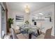 Bright dining area with glass-top table and seating, open to kitchen with modern appliances at 923 Lexington Pkwy # 14, Apopka, FL 32712