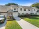 Attractive townhouse with well-maintained lawn, charming front porch and driveway at 923 Lexington Pkwy # 14, Apopka, FL 32712