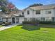 Charming townhouse with a well-manicured lawn and stone accents, offering a welcoming curb appeal at 923 Lexington Pkwy # 14, Apopka, FL 32712