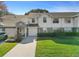 Inviting townhouse with attached garage, well-maintained lawn, and classic facade at 923 Lexington Pkwy # 14, Apopka, FL 32712