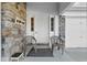 Close-up of the front porch, with stone accents, seating, and front door at 923 Lexington Pkwy # 14, Apopka, FL 32712