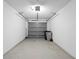 An attached one-car garage with an automatic door, concrete floor, and access for trash and recycling at 923 Lexington Pkwy # 14, Apopka, FL 32712