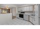 Bright, clean kitchen featuring white appliances, tile flooring, and ample counter space at 923 Lexington Pkwy # 14, Apopka, FL 32712