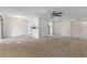 Open floor plan with neutral walls and carpets; ceiling fan and chandelier at 923 Lexington Pkwy # 14, Apopka, FL 32712