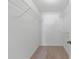 Image of a simple walk-in closet featuring wire shelving and neutral carpeting at 923 Lexington Pkwy # 14, Apopka, FL 32712