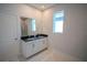 Bathroom featuring a double vanity, white cabinets, marble floors, and brushed gold hardware at 1114 Turquoise Waves Cv, Kissimmee, FL 34747