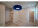 Spacious bedroom with a unique blue light fixture and two doorways, leading to more rooms at 1114 Turquoise Waves Cv, Kissimmee, FL 34747