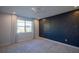 Comfortable bedroom featuring a large window, recessed lights, and a striking accent wall at 1114 Turquoise Waves Cv, Kissimmee, FL 34747