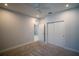 This bedroom features a ceiling fan, neutral walls and carpeting, with a closet and door at 1114 Turquoise Waves Cv, Kissimmee, FL 34747