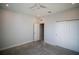 This bedroom features a ceiling fan, neutral walls and carpeting, with a closet and door at 1114 Turquoise Waves Cv, Kissimmee, FL 34747