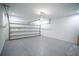 Spacious two-car garage featuring epoxy floors, white walls, and an automatic garage door opener at 1114 Turquoise Waves Cv, Kissimmee, FL 34747