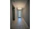 Hallway with a patterned tile floor and a view of the front door at 1114 Turquoise Waves Cv, Kissimmee, FL 34747