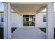This covered patio features white columns, a ceiling and an exit to the back yard at 1114 Turquoise Waves Cv, Kissimmee, FL 34747