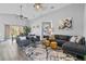 Cozy living room featuring a large sectional sofa, stylish rug, and ample natural light at 11532 Rouse Run Cir, Orlando, FL 32817