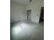 Unfinished bedroom with an open doorway showing neutral-colored walls and a bare concrete floor at 13449 Sw 60Th Avenue Rd, Ocala, FL 34473