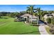 An aerial shot captures the property's expansive lawn, mature trees, and convenient circular driveway at 1384 E Lake Shore Blvd, Kissimmee, FL 34744