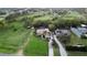 Aerial view of estate home with large lawn, mature trees, and circular driveway at 1384 E Lake Shore Blvd, Kissimmee, FL 34744