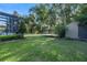 Expansive backyard featuring lush green grass, a shed, a trampoline, a playset, and mature trees perfect for outdoor activities at 1384 E Lake Shore Blvd, Kissimmee, FL 34744