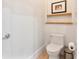 Cozy powder room features a modern toilet, floating shelves, and simple decor at 1384 E Lake Shore Blvd, Kissimmee, FL 34744