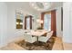 Elegant dining area with a modern table, stylish chairs, and sophisticated lighting and window treatments at 1384 E Lake Shore Blvd, Kissimmee, FL 34744