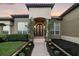 Welcoming entrance with a stone accent wall, and a beautiful iron door at 1384 E Lake Shore Blvd, Kissimmee, FL 34744