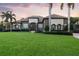 Charming home boasts a tile roof, lush lawn, and manicured bushes, offering delightful curb appeal at 1384 E Lake Shore Blvd, Kissimmee, FL 34744