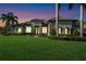 Beautiful home featuring a tile roof, lush green lawn, and elegant landscaping, creating great curb appeal at 1384 E Lake Shore Blvd, Kissimmee, FL 34744