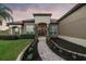 Welcoming home exterior featuring a beautiful paver walkway lined with lush landscaping at 1384 E Lake Shore Blvd, Kissimmee, FL 34744