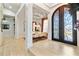 Spacious foyer featuring gleaming floors and a view into the formal dining room with luxury details at 1384 E Lake Shore Blvd, Kissimmee, FL 34744