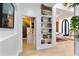 Bright hallway features built-in bookshelves and access to a small kitchenette and open-concept living area at 1384 E Lake Shore Blvd, Kissimmee, FL 34744