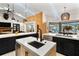 Modern kitchen with stainless steel appliances, black cabinets and white countertops at 1384 E Lake Shore Blvd, Kissimmee, FL 34744