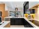 Bright kitchen with stainless steel appliances, black cabinets, and view of the pool at 1384 E Lake Shore Blvd, Kissimmee, FL 34744
