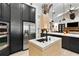 Open kitchen with island sink, stainless steel appliances, and brick fireplace at 1384 E Lake Shore Blvd, Kissimmee, FL 34744