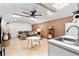 Comfortable living room with high ceilings boasts neutral decor, kitchenette and a large ceiling fan at 1384 E Lake Shore Blvd, Kissimmee, FL 34744