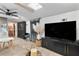 Light-filled living area features a large tv, comfortable seating and a partial view of the kitchenette at 1384 E Lake Shore Blvd, Kissimmee, FL 34744